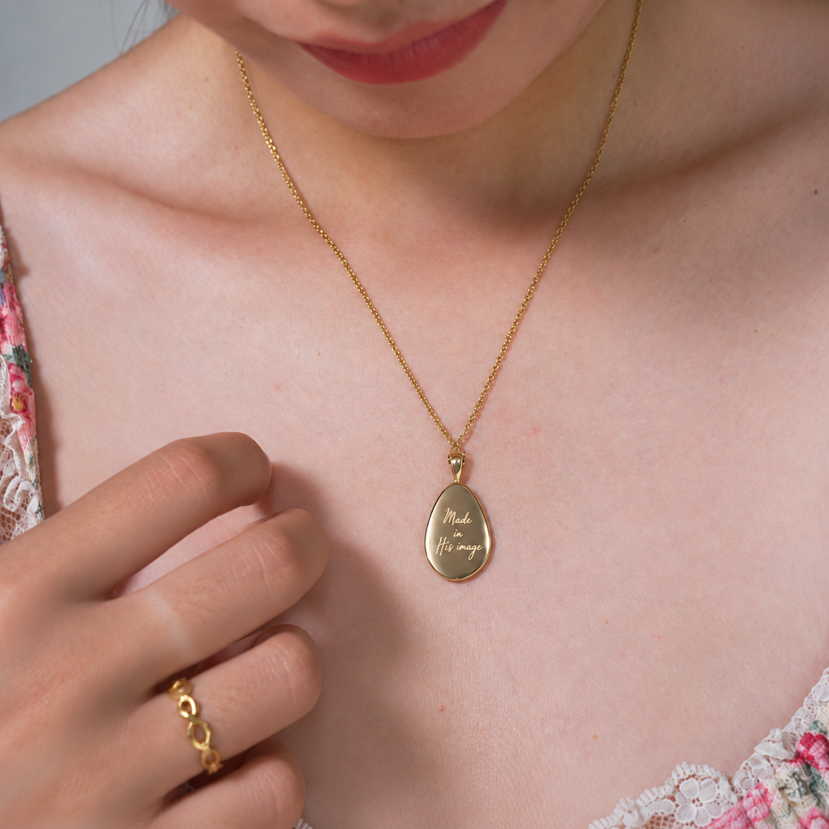 Fingerprint gold pendant showing Made in His image engraving, worn with matching ring