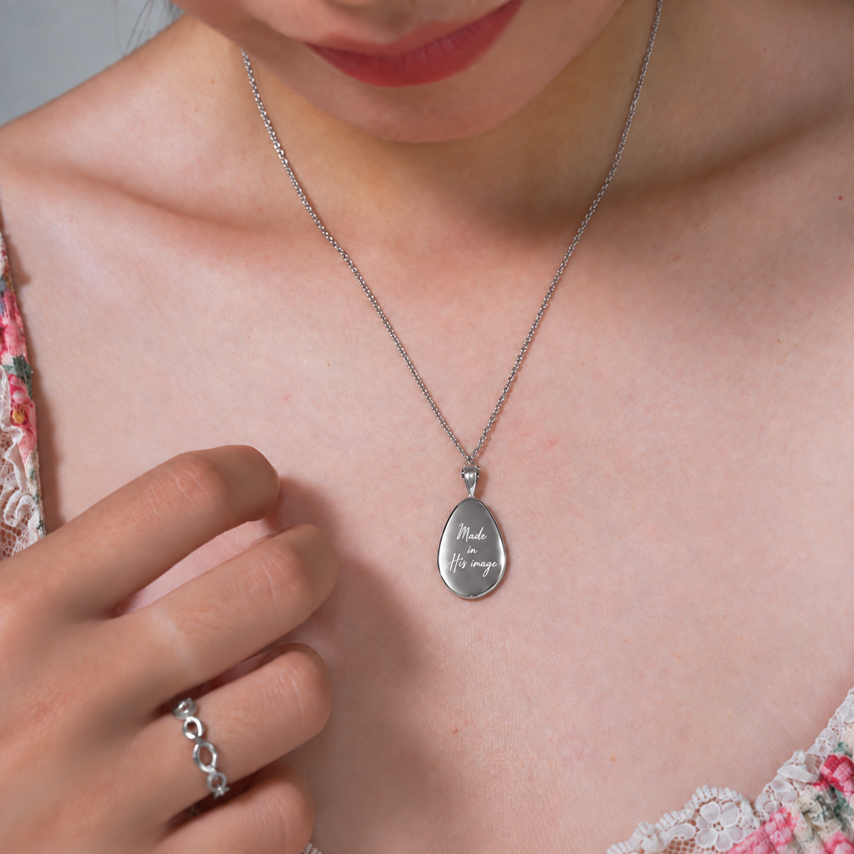 Fingerprint silver pendant showing Made in His image engraving, worn with matching ring
