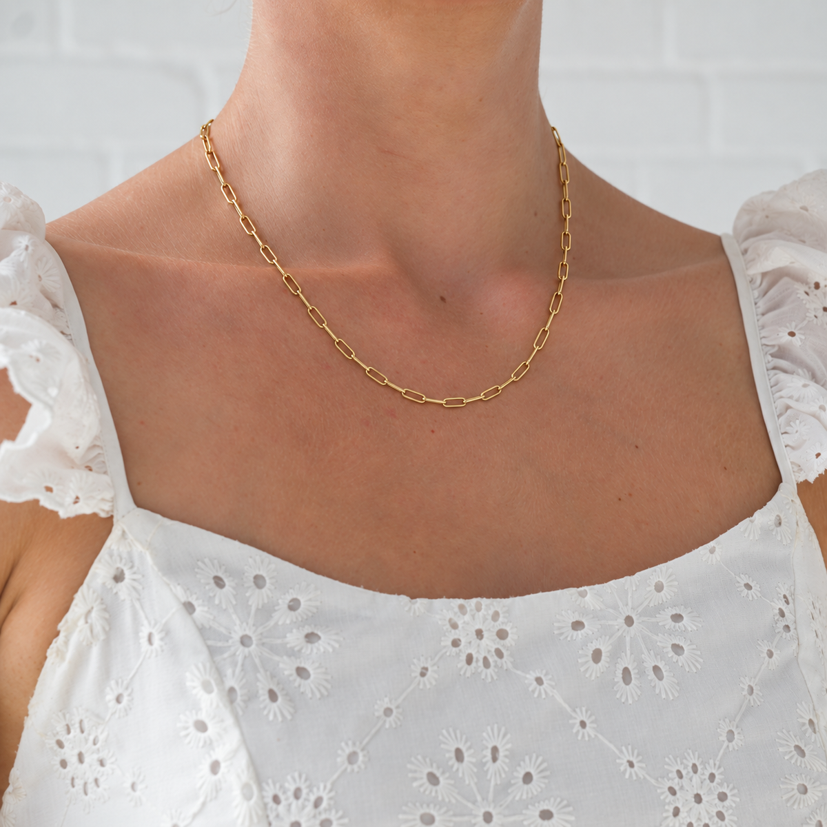 Paperclip Chain in gold worn with white embroidered dress