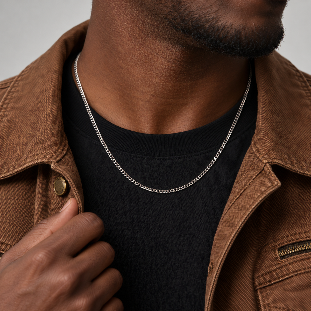 2mm silver Cuban chain, brown workwear jacket model photograph.