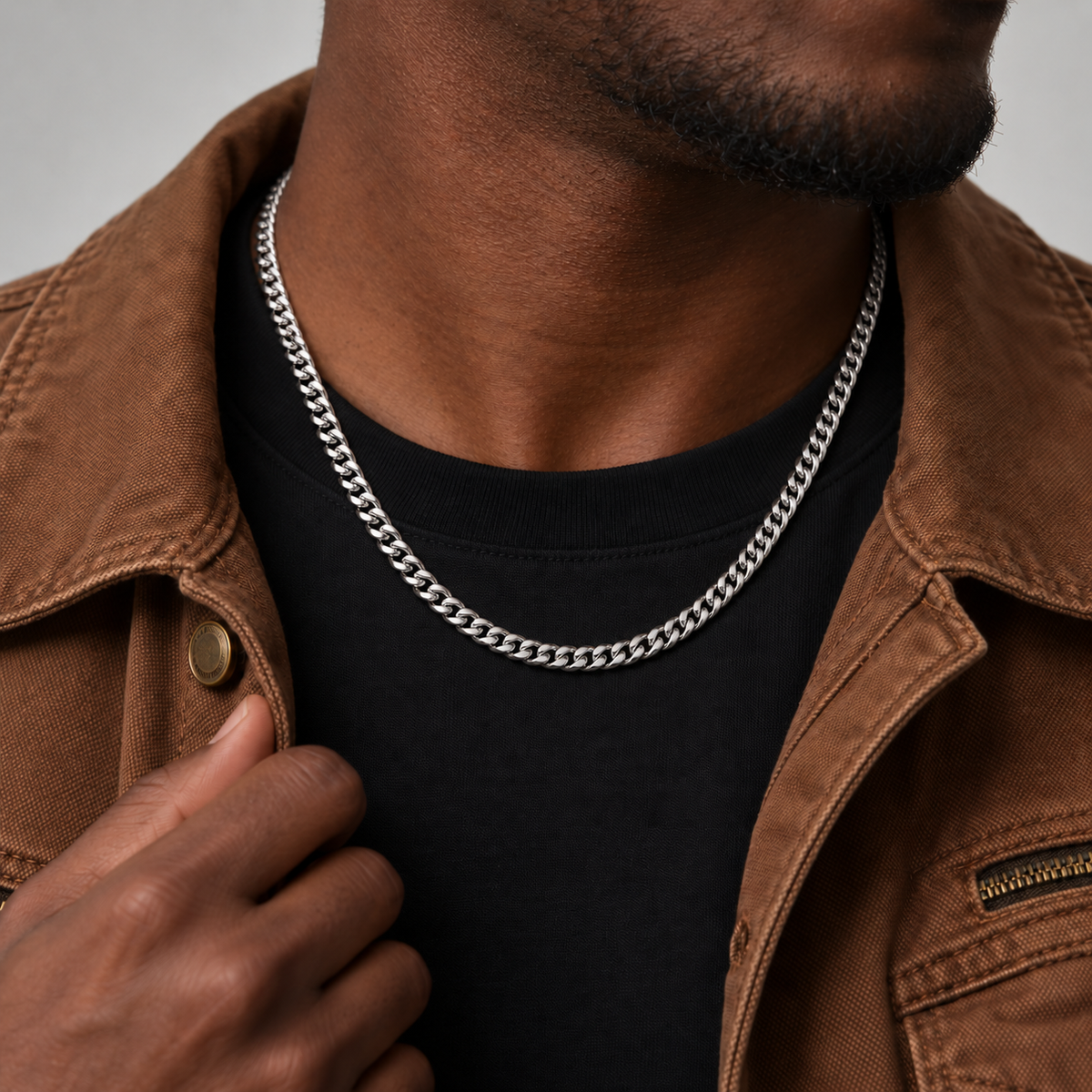 6mm silver Cuban chain, brown workwear jacket, Unveiled website product photograph.