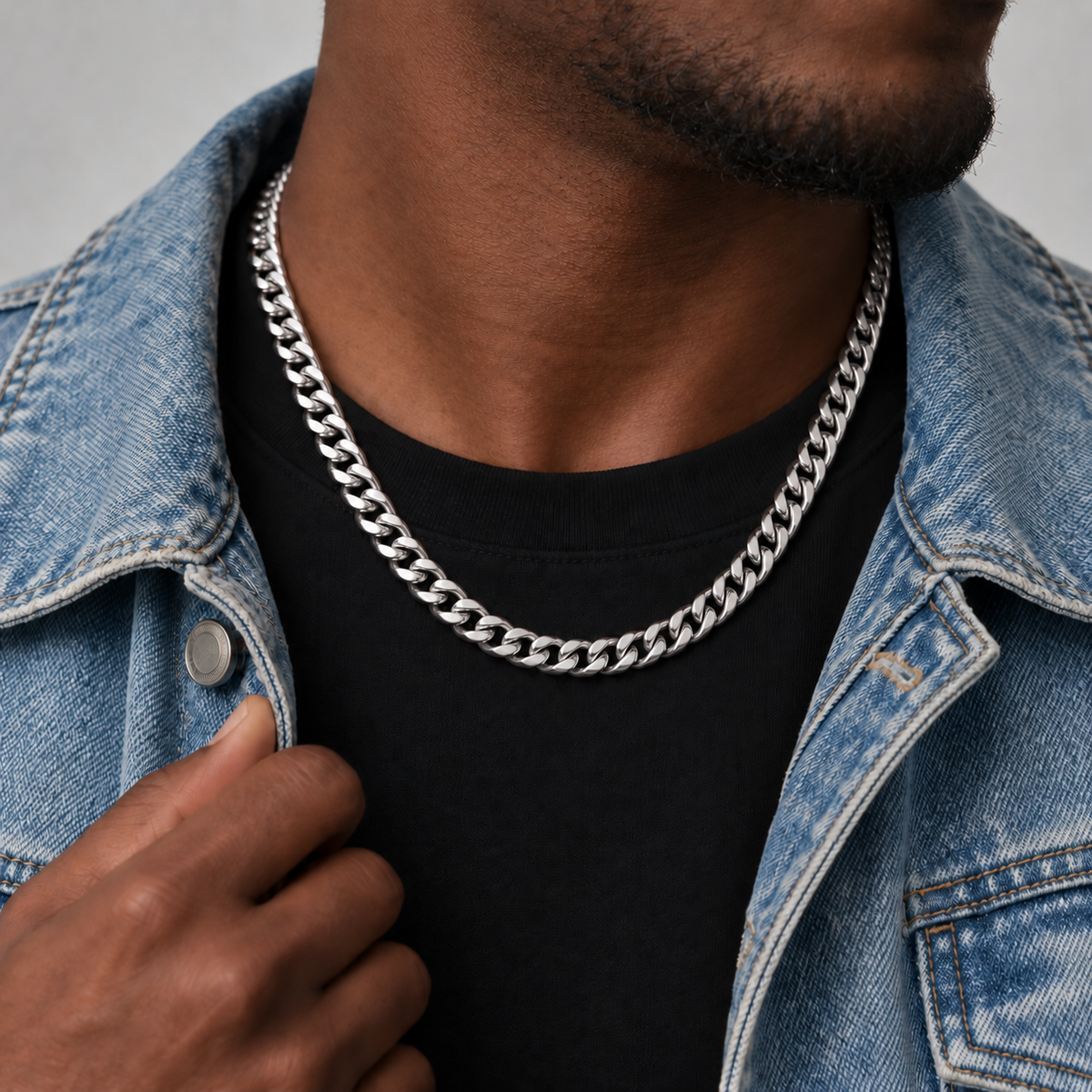 8mm silver Cuban chain, washed blue denim, Unveiled website product photograph.