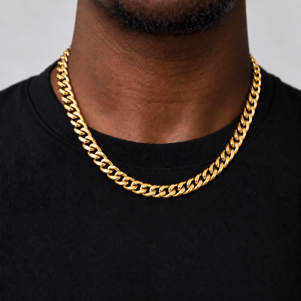 8mm 18k PVD gold Cuban chain, black tee studio, Unveiled website product photograph.