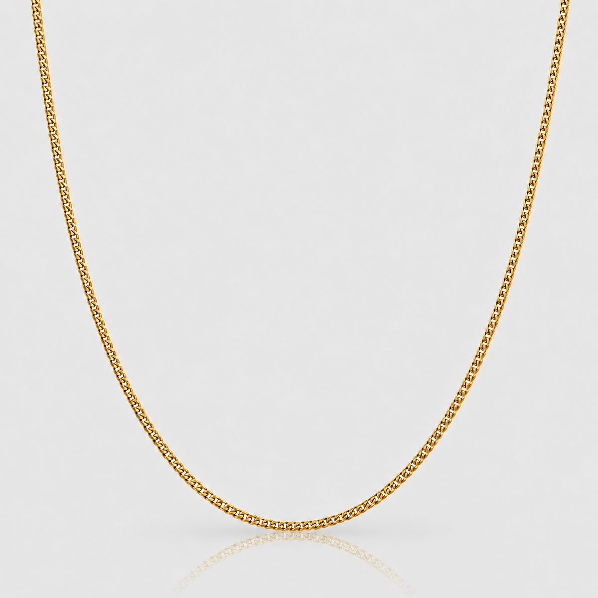 2mm Cuban chain in 18k PVD gold finish on Unveiled light-grey background, standalone product photograph.