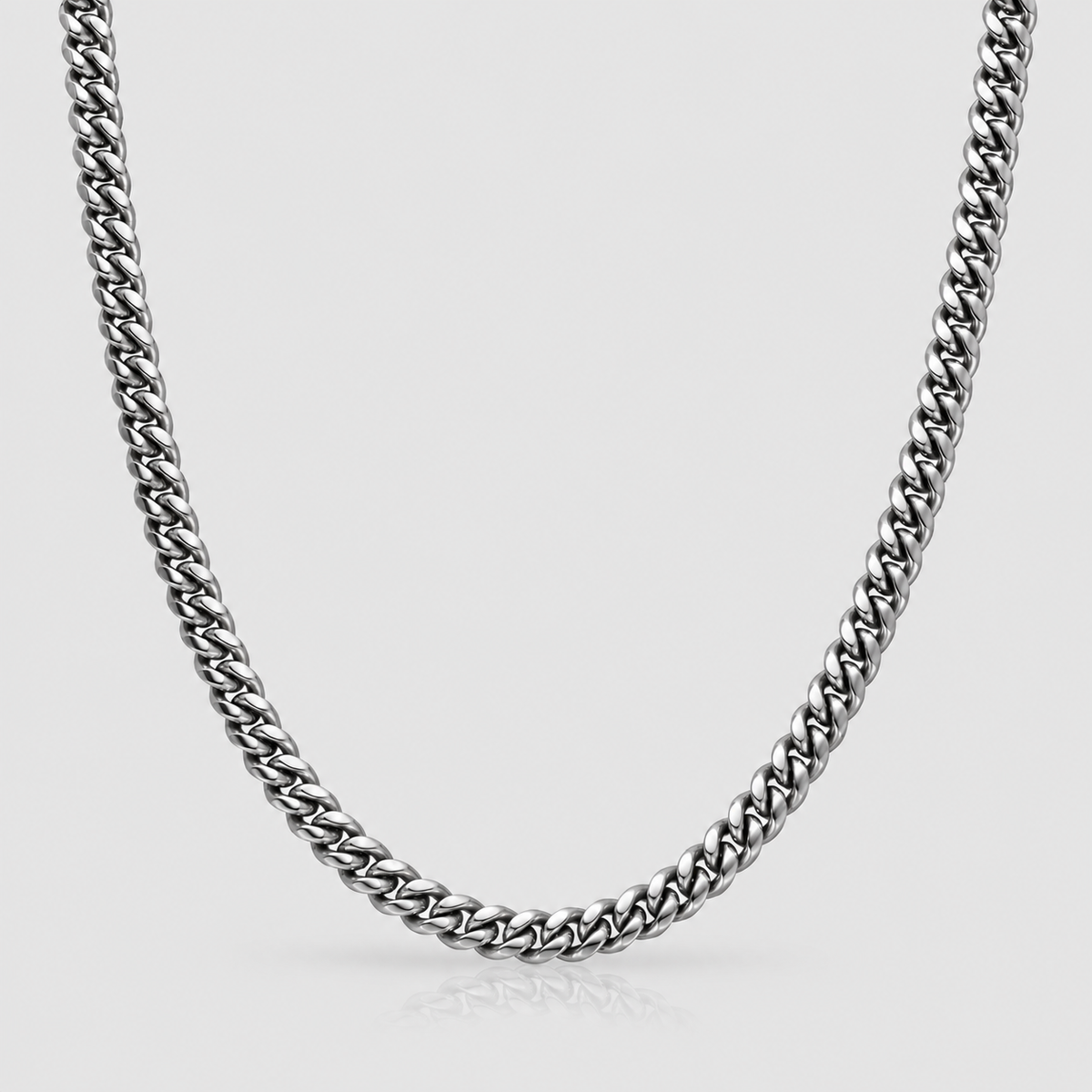 6mm silver Cuban chain on Unveiled light-grey background, standalone product photograph.