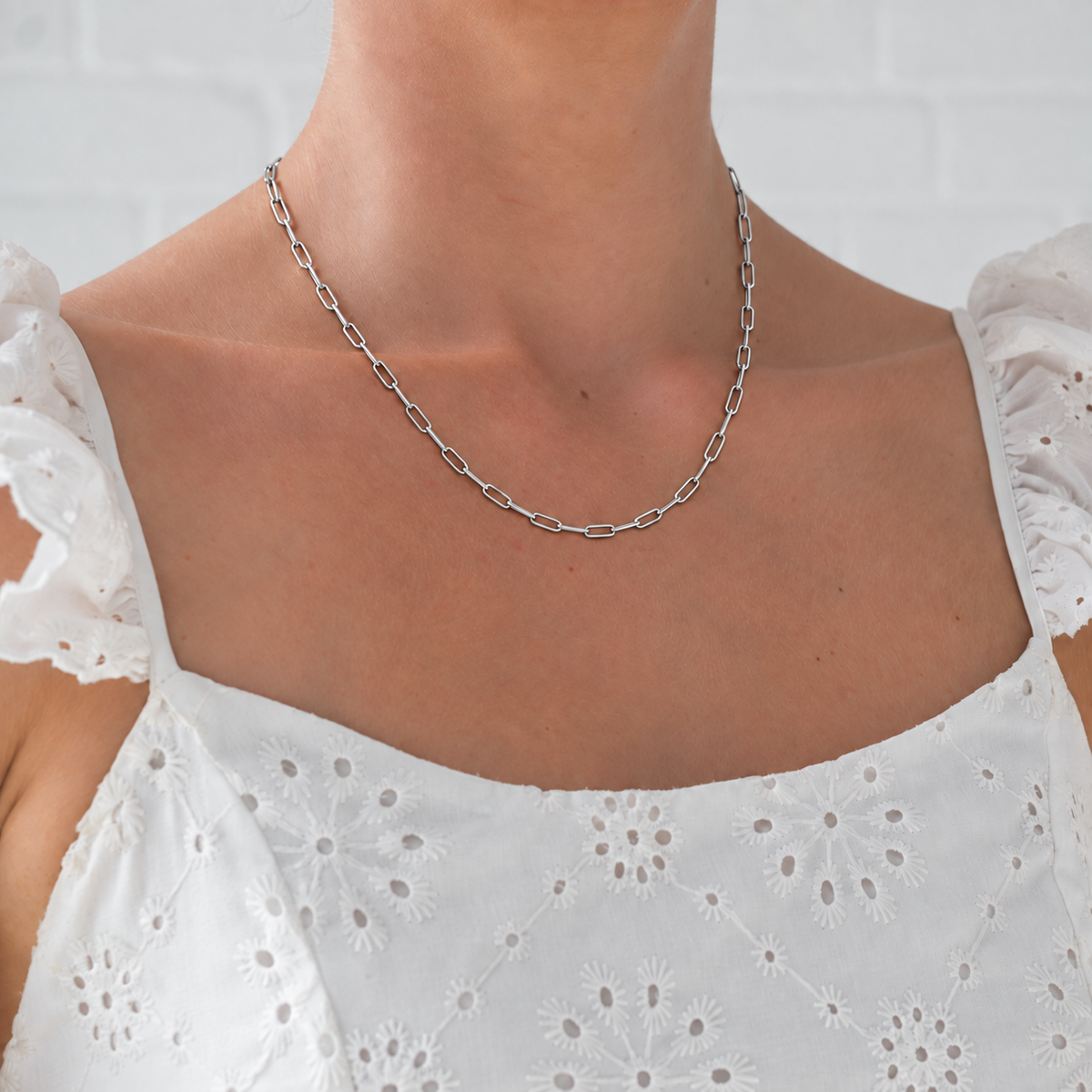 Paperclip Chain in silver worn with white embroidered dress