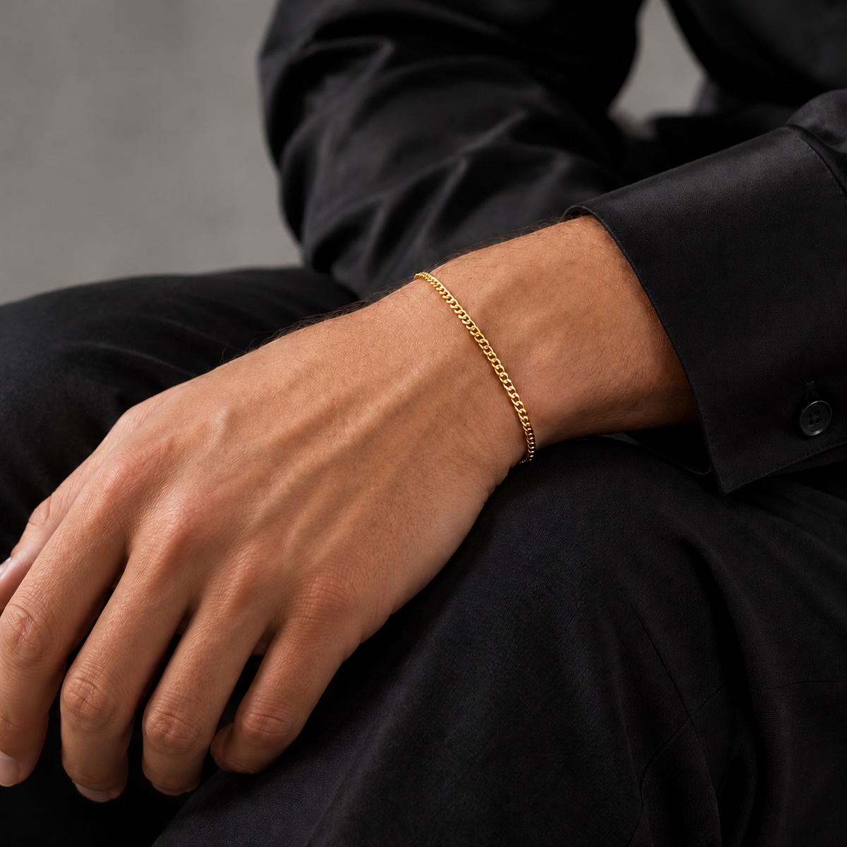 Gold 2mm Cuban bracelet, seated model view